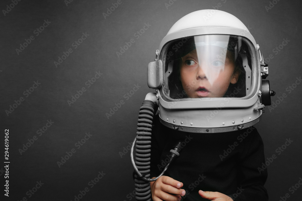 Small child wants to fly an airplane wearing an airplane helmet Small child wants to fly an airplane wearing an airplane helmet