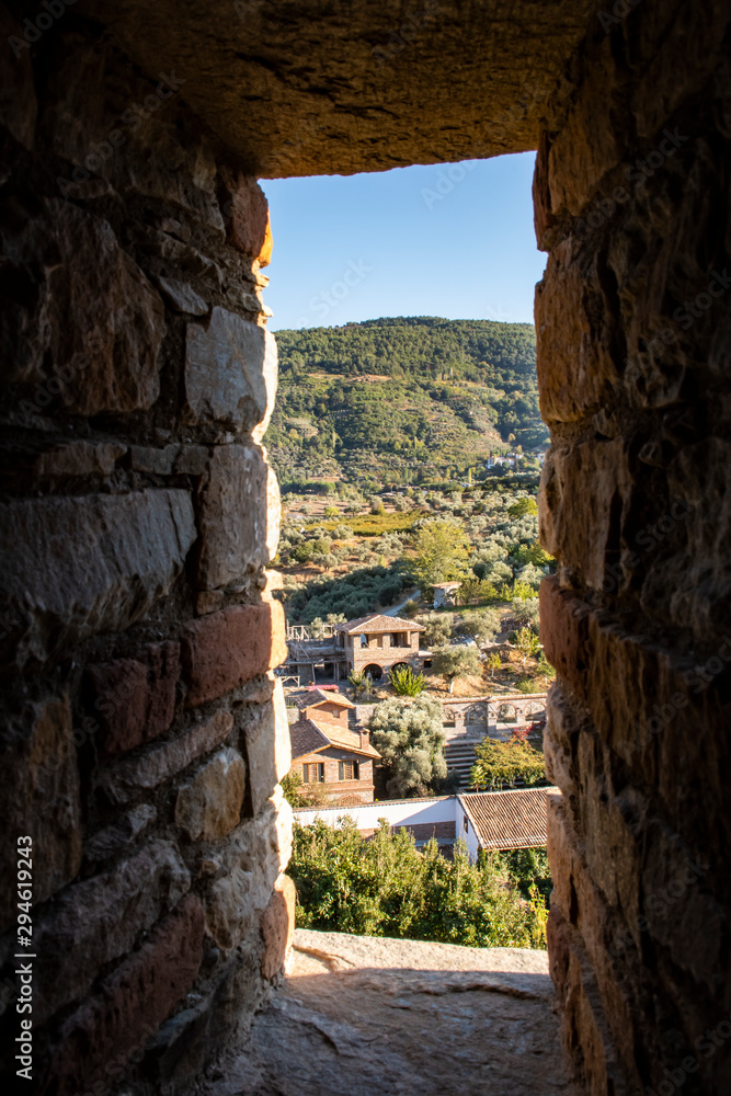 Houses appearing through stone window. At Sirince. 