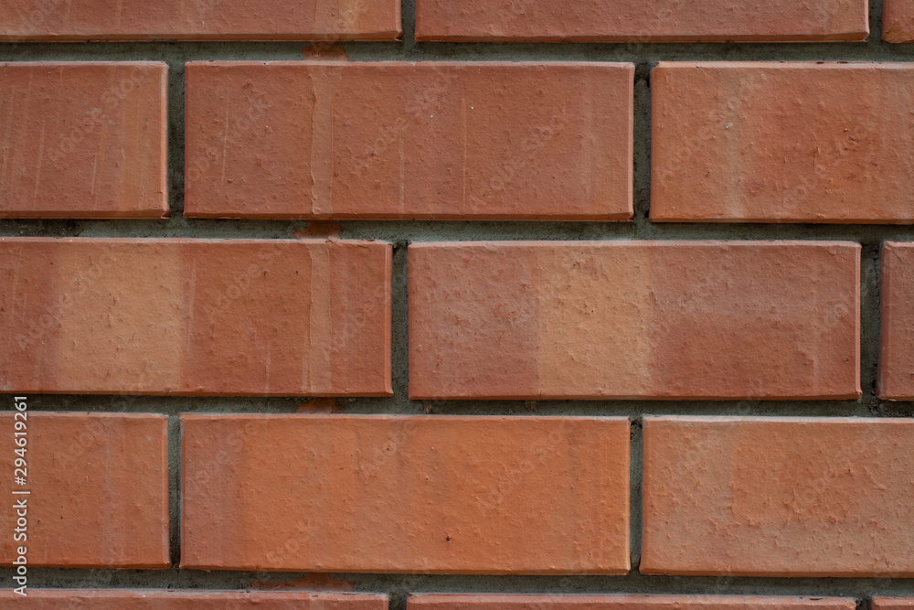 Obraz premium Red bricks wall with concrete marks pattern background macro