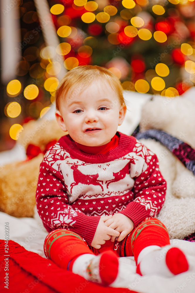 Happy fun child paying at home on Christmas time. Xmas holiday concept Happy fun child paying at home on Christmas time. Xmas holiday concept