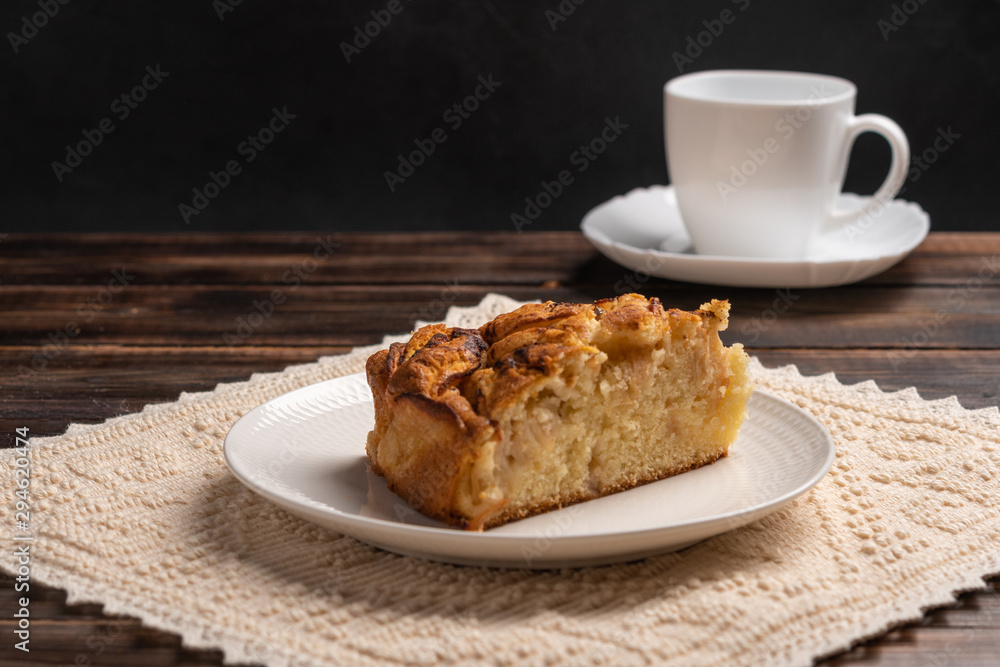Piece of homemade traditional cornish apple pie on a white plate on the napkin. Close up. Selective focus Piece of homemade traditional cornish apple pie on a white plate on the napkin. Close up. Selective focus