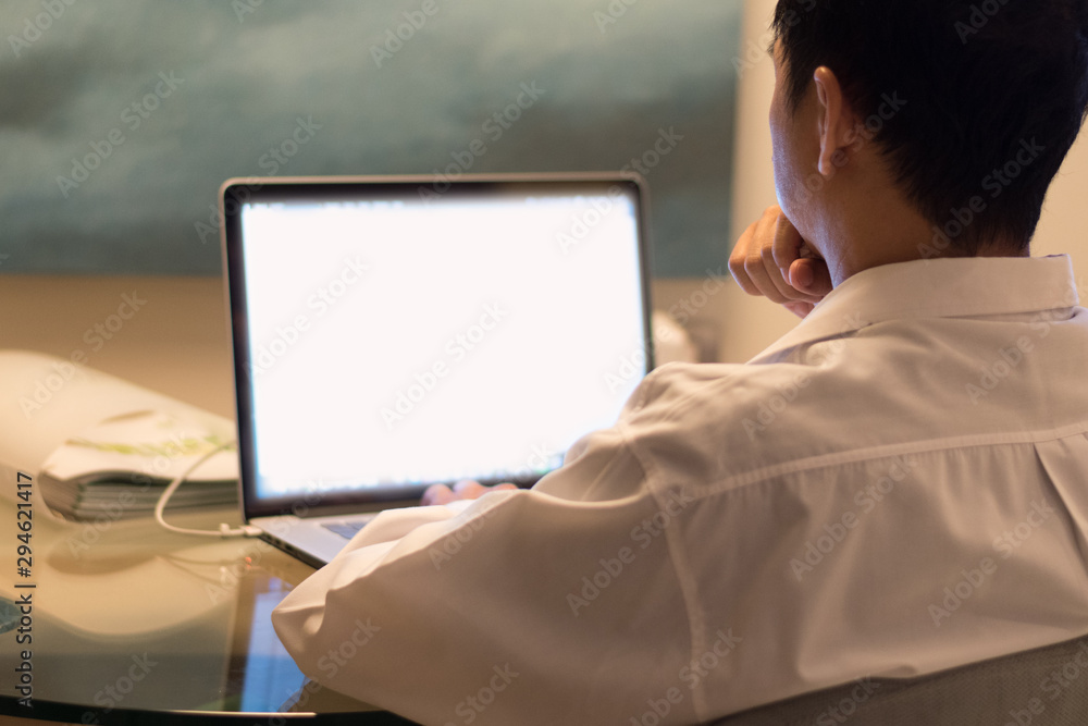 Business man hard working concept. Back of businessman work on multichannel devices notebook laptop computer and smartphone at night using 5g and wireless wifi network from home Business man hard working concept. Back of businessman work on multichannel devices notebook laptop computer and smartphone at night using 5g and wireless wifi network from home
