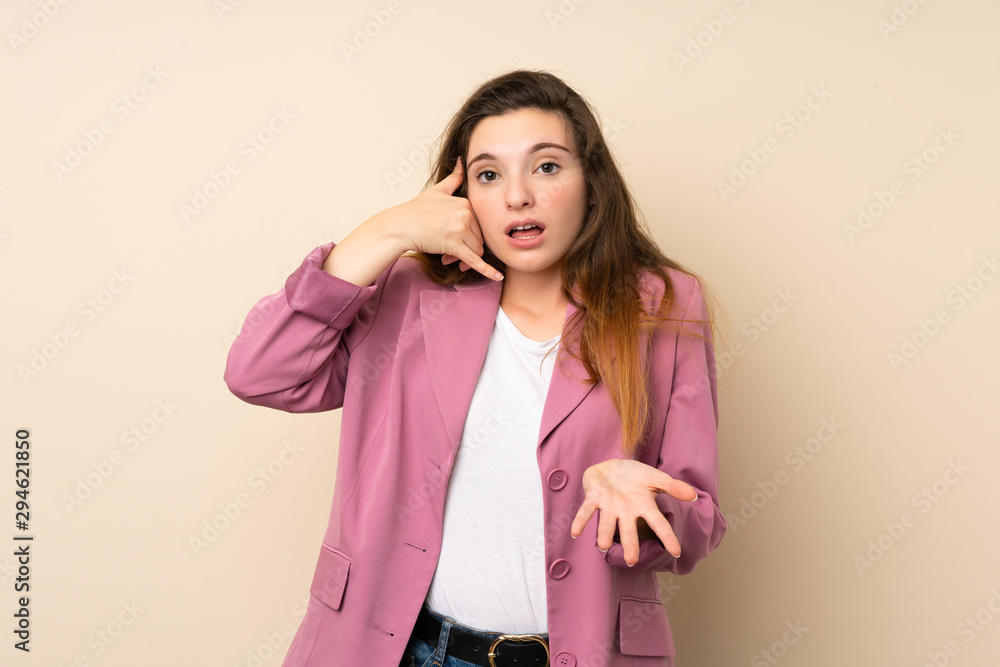 Young brunette girl with blazer over isolated background making phone gesture and doubting Young brunette girl with blazer over isolated background making phone gesture and doubting