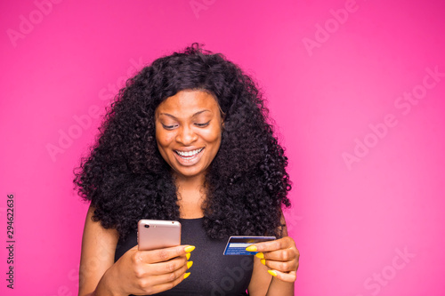 A beautiful nigerian lady shopping online with her smartphone