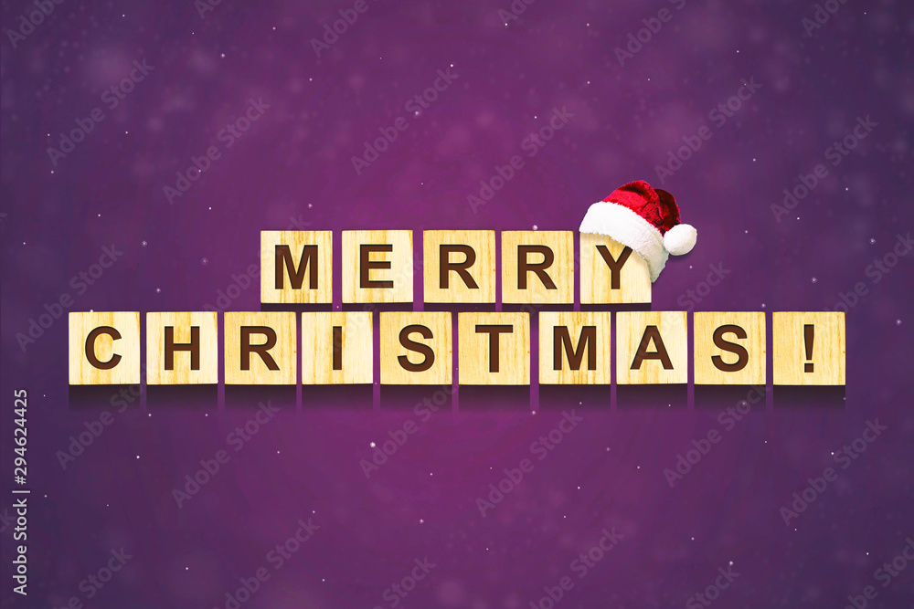 Merry Christmas lettering on wooden blocks on a dark background. Christmas card. F Merry Christmas lettering on wooden blocks on a dark background. Christmas card. F