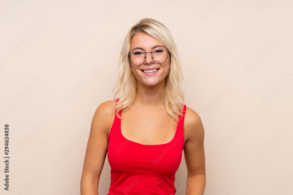 Young blonde woman over isolated background with glasses Young blonde woman over isolated background with glasses