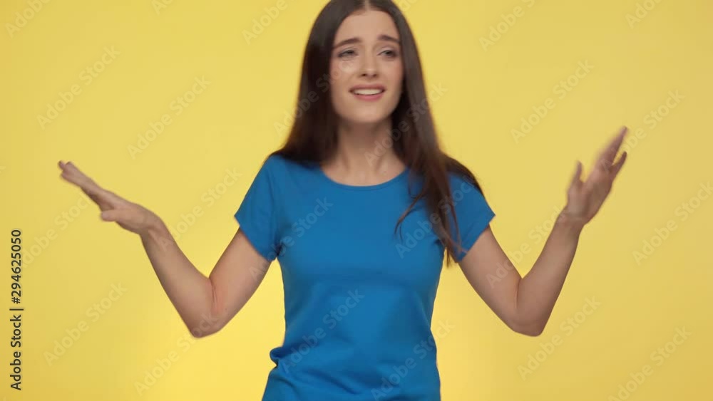 pretty girl pointing with fingers and dancing isolated on yellow pretty girl pointing with fingers and dancing isolated on yellow