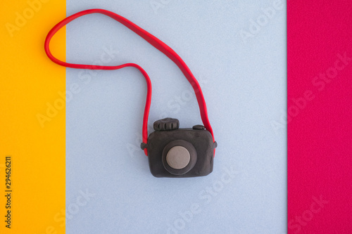 Black digital camera on a colorful background