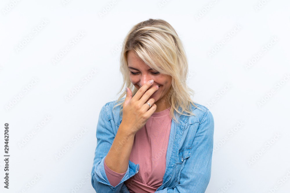 Young blonde woman over isolated white background smiling a lot Young blonde woman over isolated white background smiling a lot