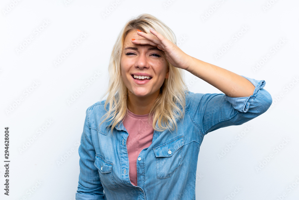 Young blonde woman over isolated white background looking far away with hand to look something Young blonde woman over isolated white background looking far away with hand to look something