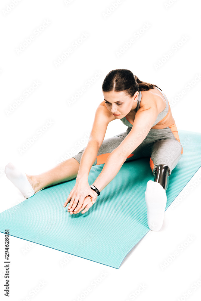 overhead view of disabled sportswoman stretching on fitness mat isolated on white overhead view of disabled sportswoman stretching on fitness mat isolated on white