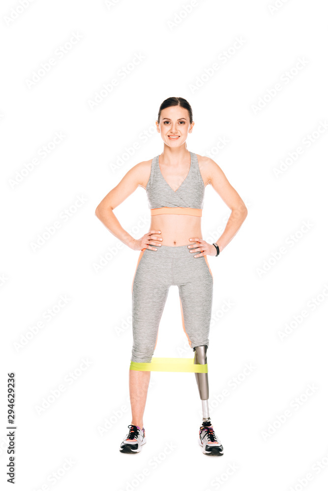 full length view of smiling disabled sportswoman with resistance band isolated on white full length view of smiling disabled sportswoman with resistance band isolated on white