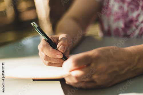 Woman taking notes outdoors