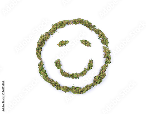 Top view of smile symbol emoji made of fresh green marijuana flowers or buds isolated on white background. Alternative treatment. Medical cannabis.