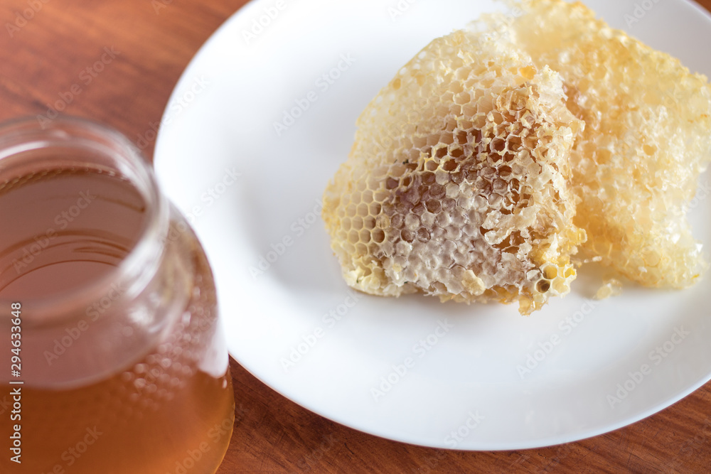 Fresh honey jar with flowers and honeycomb, delicious biological product. Fresh honey jar with flowers and honeycomb, delicious biological product.