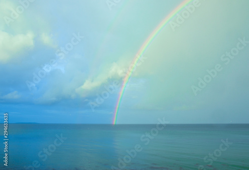 Fototapeta Naklejka Na Ścianę i Meble -  Beautiful, bright, lucent and real rainbow across the ocean