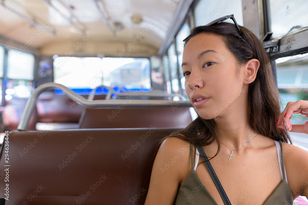 Young tourist woman exploring the city of Bangkok with bus Young tourist woman exploring the city of Bangkok with bus