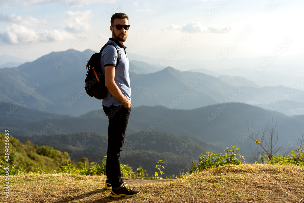 tourist guy stands on the edge of the mountains in thailand