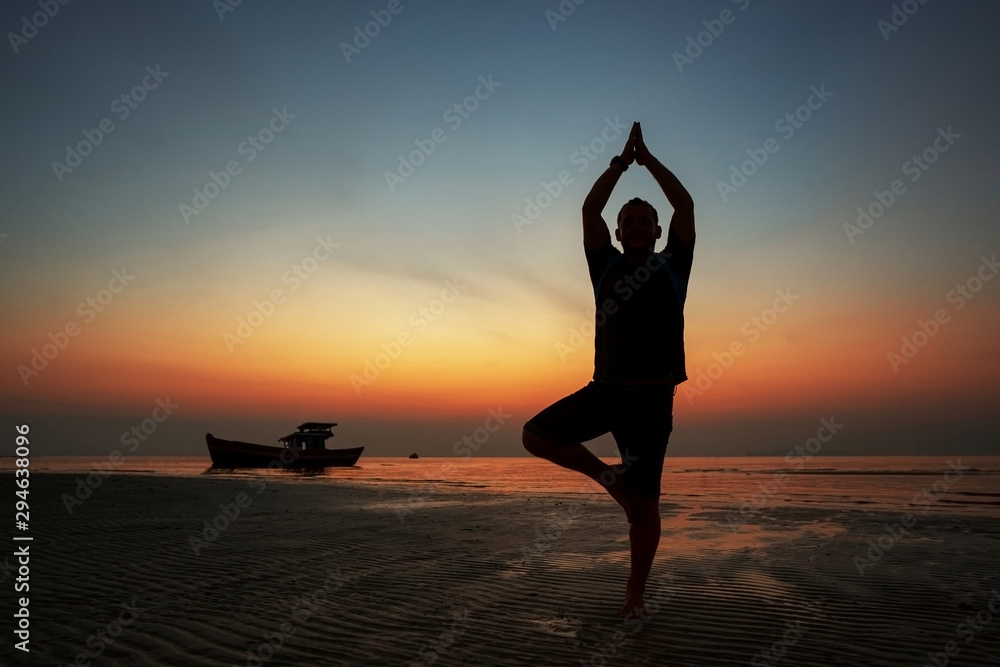 guy at sunset on the island practices yoga, silhouette guy at sunset on the island practices yoga, silhouette