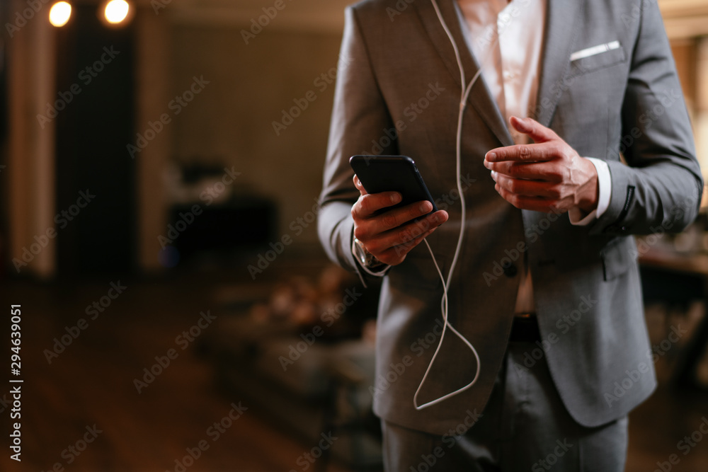 Businessman in grey suit with headphones