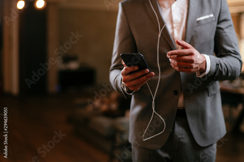 Businessman in grey suit with headphones