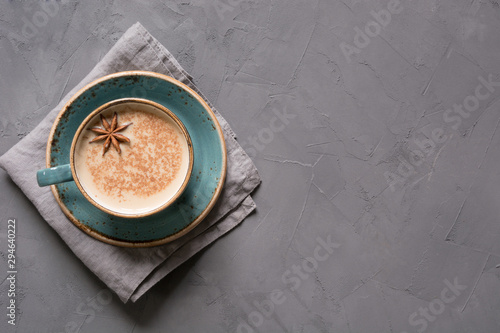 Fotografie Masala Indian tea or coffee in blue cup with spices and cinnamon on black
