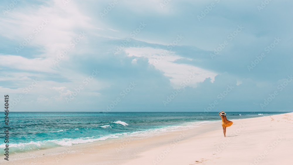 Woman walking in blue lagoon with paradise view Woman walking in blue lagoon with paradise view