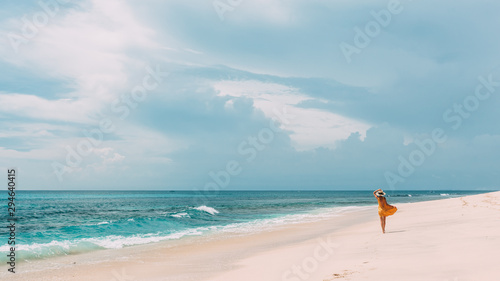 Woman walking in blue lagoon with paradise view