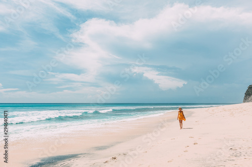 Woman walking in blue lagoon with paradise view