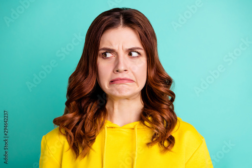 Close up photo of disgusted youngster envious with hating facial expression furious angry isolated over teal vivid color background