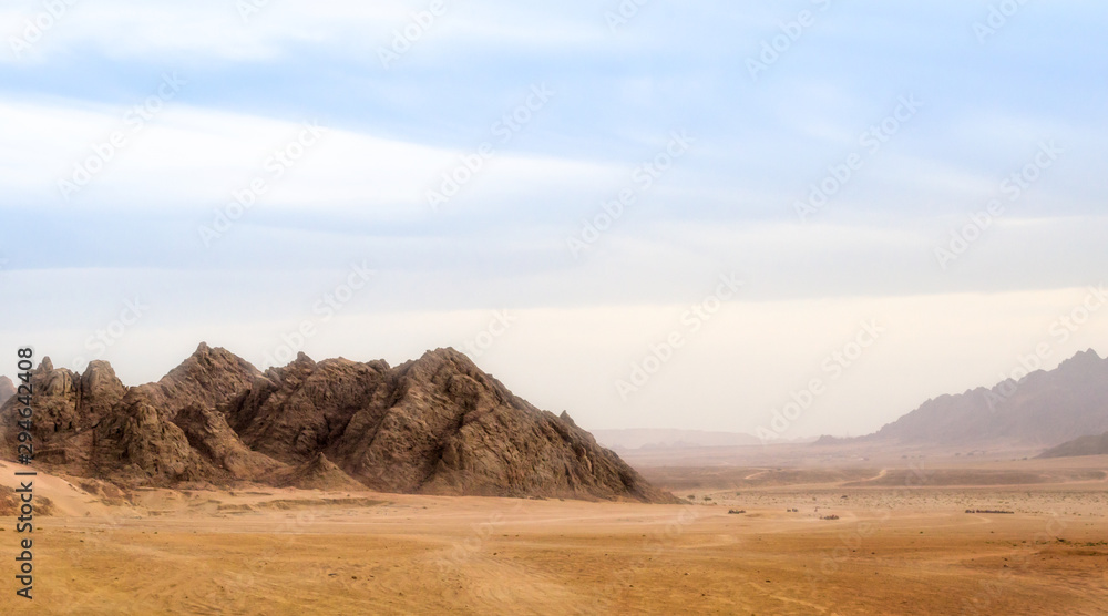landscape of desert and high rocky mountains against the blue sky and clouds in Egypt in Sharm El Sheikh