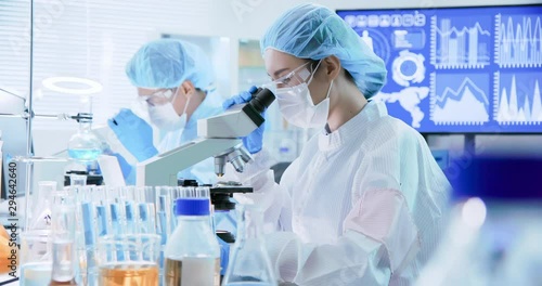 asian scientist use microscope