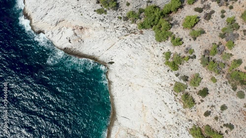 Drone flying along rocky coast line and dreep blue sea water. Beautiful blue sea water. photo