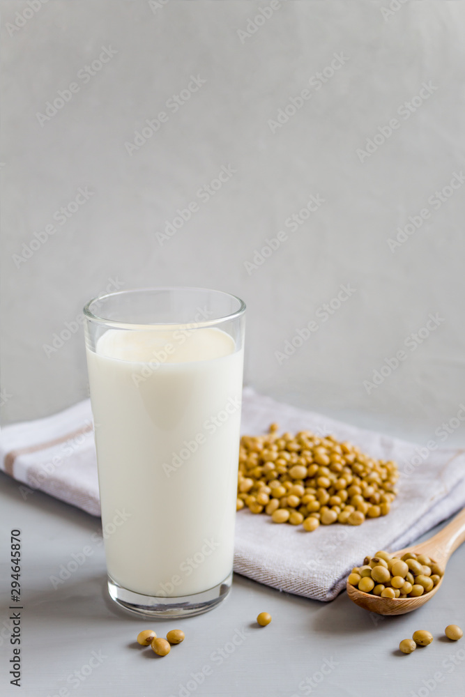 Soy milk in a glass and beans in a plate. The concept of healthy eating. Vegetarian food. Vegetable drink. Copy space, side view. Soy milk in a glass and beans in a plate. The concept of healthy eating. Vegetarian food. Vegetable drink. Copy space, side view.