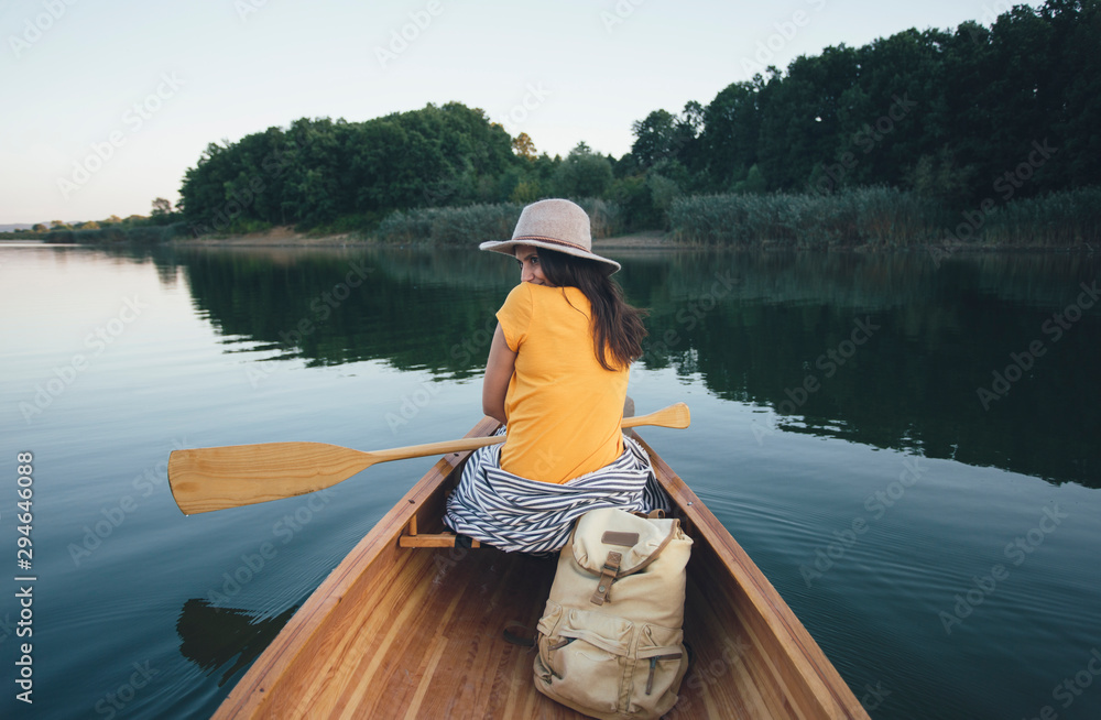 Shy canoe girl hiding her look back Shy canoe girl hiding her look back