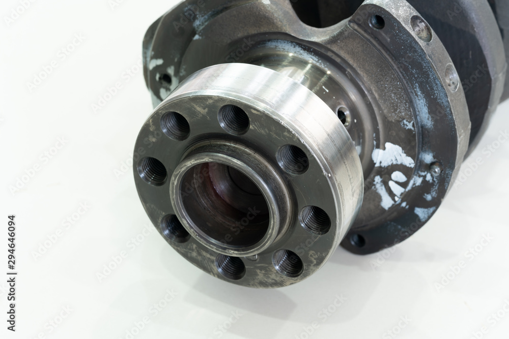 crankshaft of the diesel engine on a white background. flange of fastening of a flywheel to the crankshaft. crankshaft of the diesel engine on a white background. flange of fastening of a flywheel to the crankshaft.