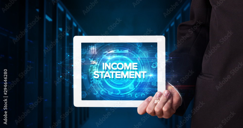 Young business person working on tablet and shows the inscription: INCOME STATEMENT, business concept Young business person working on tablet and shows the inscription: INCOME STATEMENT, business concept