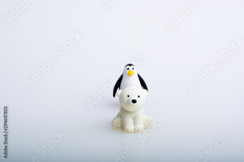 Penguin and polar bear rubber toys, cute animal shaped rubber doll isolated in white background. 