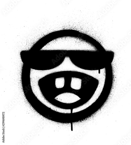 graffiti sprayed icon with sunglasses laughing out loud