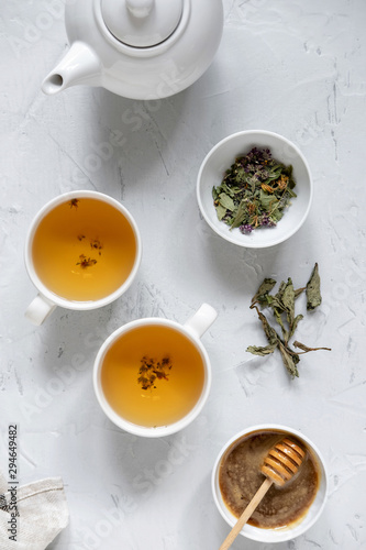 Floral green tea on table with tea kettle and napkin