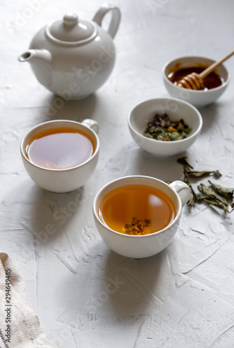 Floral green tea on table with tea kettle and napkin