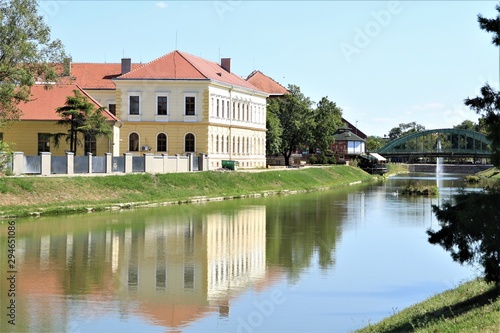 City landscape: river, bridge, old restored building. © Ruslan