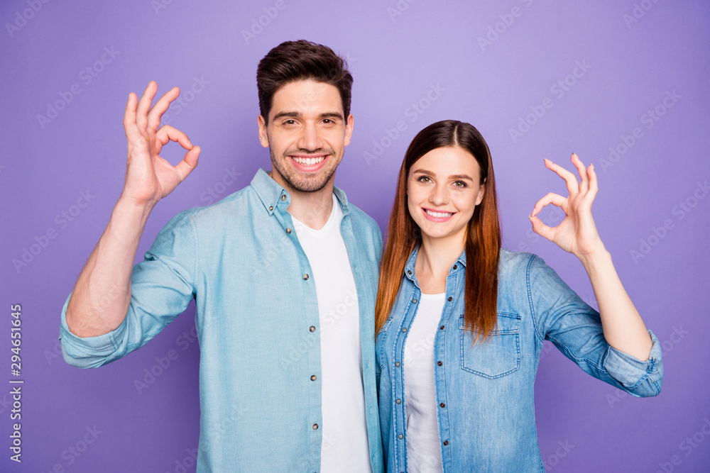 Portrait of lovely romantic spouses show ok okay recommend choice decision indicate great discounts wear denim jeans outfit isolated over violet color background Portrait of lovely romantic spouses show ok okay recommend choice decision indicate great discounts wear denim jeans outfit isolated over violet color background
