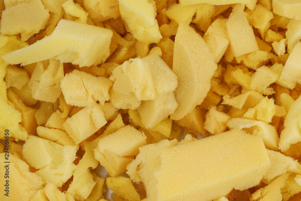 yellow polyurethane foam rubber pieces background texture. stuffing for pillows and furniture yellow polyurethane foam rubber pieces background texture. stuffing for pillows and furniture