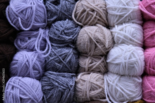 multi-colored balls of yarn: lilac, gray, light brown, white, pink