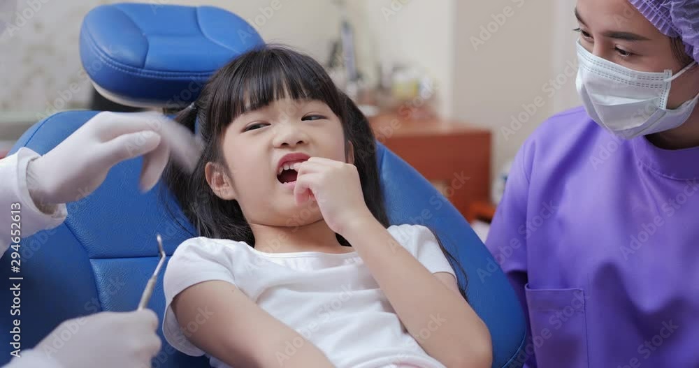 Little girl in a patient in a dental clinic. Doctor checking little mouth in lab. Dental care concept. Little girl in a patient in a dental clinic. Doctor checking little mouth in lab. Dental care concept.