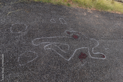 Crime scene chalk outline of victim dead body on Road with blood, Concept of murder investigation.