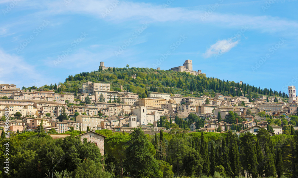 Panoramic view of the historic town of Assisi in beautiful sunny day with blue sky and clouds in summer, Umbria, Italy.