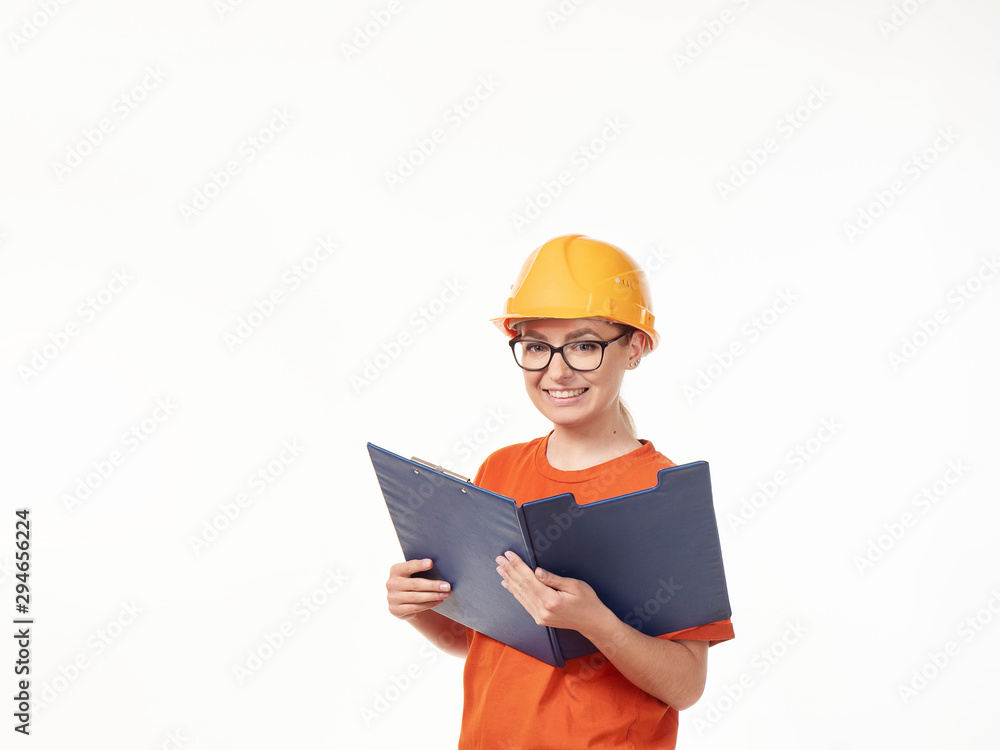 beautiful foreman girl in a yellow helmet with a blue folder on a white background beautiful foreman girl in a yellow helmet with a blue folder on a white background