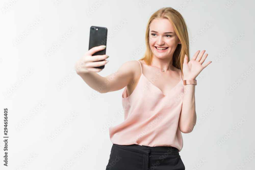 Girl waving on the smart phone while during a video call isolated on white background Girl waving on the smart phone while during a video call isolated on white background